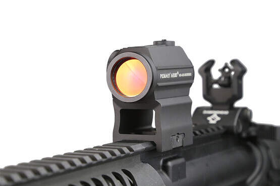 ThePrimary Arms absolute co witness red dot riser mount attached to an AR15